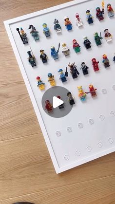 lego minifigures are arranged on a white board and placed in front of a computer keyboard