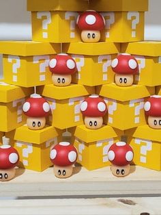 a bunch of nintendo mushroom themed boxes stacked on top of each other with question marks painted on them