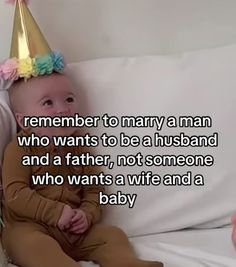 a baby wearing a party hat sitting on top of a couch next to a pillow