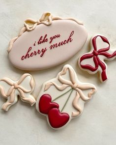 three decorated cookies with the words i like you cherry munch on them and bows