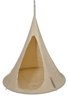 a white hanging chair with a beige cover on it