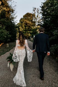 Bride in boho lace wedding dress with cutouts walking with the groom in a black suit for outdoor wedding Preston Court Wedding, Pastel Wedding Theme, Beach Bridal Dresses, Boho Inspo, Wedding Dress Fabrics, Boho Lace