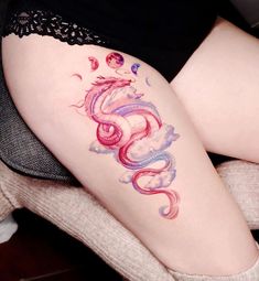 a woman's thigh with a dragon tattoo on it