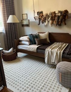 a bed sitting in the middle of a living room next to a chair and ottoman