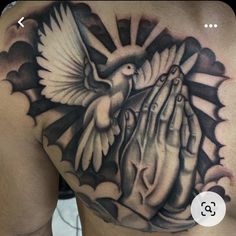 a man's chest with a dove and hands tattoo on it