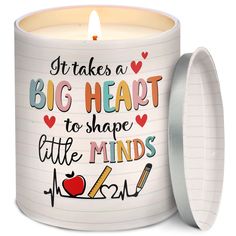 a white candle with the words, it takes a big heart to shape little minds