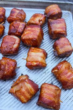 bacon bites on a grill with toothpicks in them