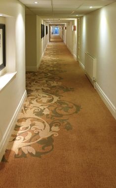 a long hallway with carpeted floors and white walls