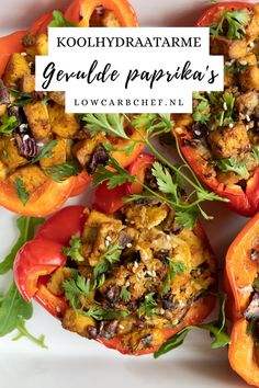 several stuffed peppers with herbs and seasoning in them on a white plate next to the words kohlhydraatame gruele paprika's