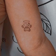 a small paw print on the arm of a woman's left arm and wrist