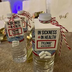 two bottled water bottles with labels on them sitting on a table next to some candy canes