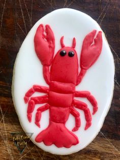 a cake decorated like a red lobster on a white plate