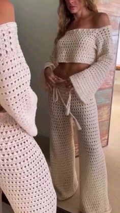 two women in white crochet outfits looking at each other's butts