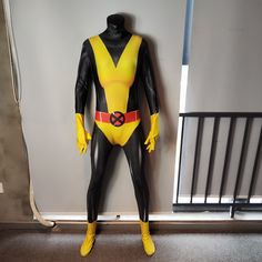 a yellow and black costume is on display