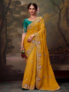 Crafted with care and attention to detail, this saree is perfect for those who appreciate fine craftsmanship and unique design. The light color exudes elegance and sophistication, making it a standout choice for any special occasion. Whether you're attending a wedding or celebrating a festival, this saree is sure to make you feel like a true queen. Make a statement with our attractive organza saree, designed to turn heads and leave a lasting impression.  --------------------------------- S A R E E ● D E T A I L S --------------------------------- ● Fall and Edging : Done ● Tassel : See in Option ● Petticoat : On request Extra Charges ● Drapping Saree (Ready to wear) : On Request Extra Charges ● Blouse : Matching Unstitched Piece (See in option) ● Occasion : Wedding, Party, Festive, Functio Yellow Half Saree, Mustard Yellow Saree, Designer Silk Sarees, Yellow Saree, Embroidery Saree, Trendy Sarees, Art Silk Sarees, Top Models, Saree Dress