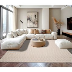 a living room filled with lots of furniture and large windows overlooking the cityscape