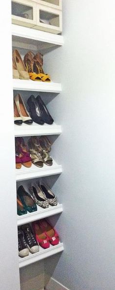 a white closet filled with lots of shoes