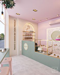 the interior of a pastry shop with pastel pink walls and gold trimmings