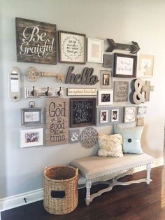 a wall filled with lots of different types of framed pictures and letters on it's side