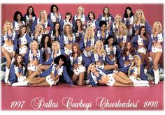 a group of cheerleaders posing for a photo in front of a pink background