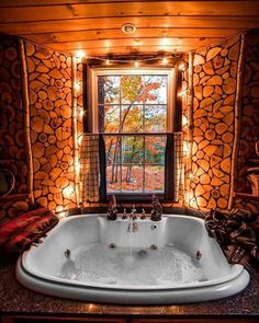 a bathroom with a large jacuzzi tub next to a window filled with lights