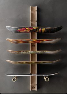 the skateboard rack is made out of wood and has five boards attached to it