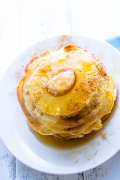 a stack of pancakes sitting on top of a white plate