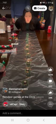 a woman sitting at a long table with christmas decorations on it and an empty message bubble above her