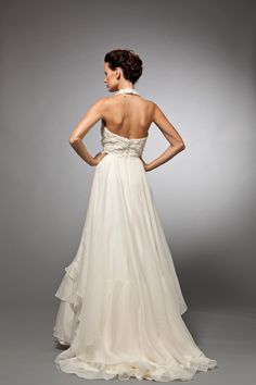 the back of a woman's wedding dress with ruffled skirt and halter