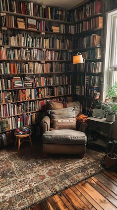 Cozy reading nook with armchair, throw pillows, and bookshelves, ideal for book enthusiasts. House Filled With Books, Book Shelf Library Design, 70s Home Library, Books Above Couch, Book Closet Ideas, Reading Book Bedroom, Bookish Living Room, Small Libraries In Houses, Dark Academia Reading Nook