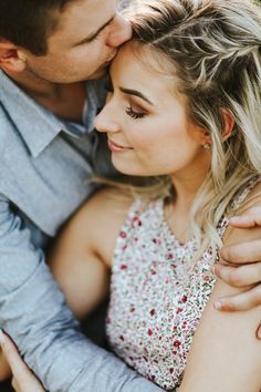 a man and woman are hugging each other