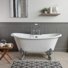 a white bath tub sitting on top of a bathroom floor