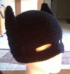 a knitted batman hat on top of a mannequin head