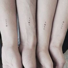 three people with matching tattoos on their arms