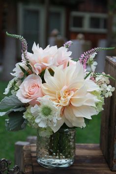 a vase filled with flowers on top of a wooden table