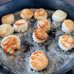 some scallops are cooking in a skillet on the stove top with oil