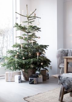 a small christmas tree in the corner of a room