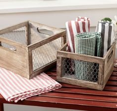 two wooden crates filled with napkins on top of a table