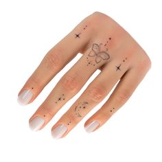 a woman's hand with a butterfly and stars tattoo on her left ring finger