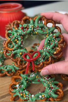 someone is decorating some pretzels in the shape of wreaths