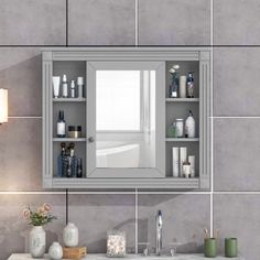 a bathroom sink with a medicine cabinet and mirror on the wall next to it,