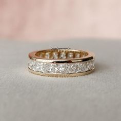 a wedding band with princess cut diamonds on it