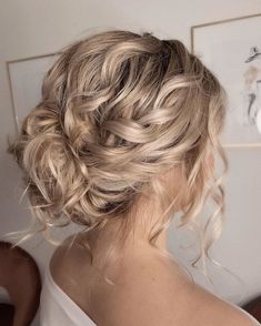 a woman with blonde hair in a messy updo