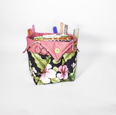 a pink and black flowered purse with scissors