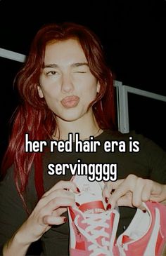 a girl with red hair is trying to put on her converses shoes and the caption reads, her red hair era is serving