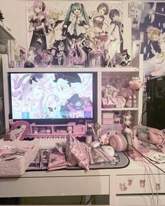 a desktop computer sitting on top of a desk covered in anime pictures and toys,