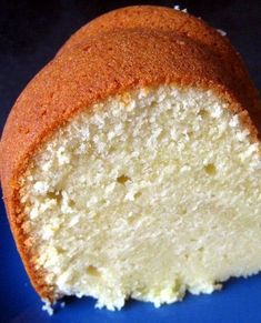 a close up of a piece of cake on a blue plate with white frosting