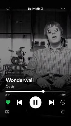 a black and white photo of a person on a cell phone with the words wonderwall