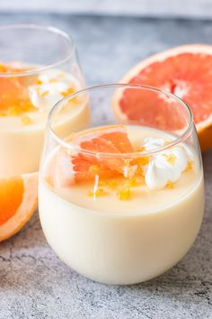 two glasses filled with yogurt and garnished with grapefruits