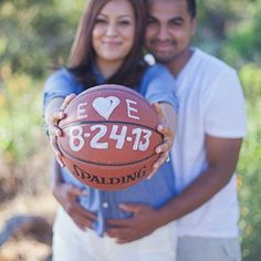 a man and woman holding a basketball in their hands